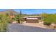 Desert home with lush landscaping, mountain views, private drive, and two-car garage at 1702 E Staghorn Ln, Carefree, AZ 85377