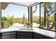 Bright kitchen corner with stainless steel sink and faucet, framed by a large window with desert views at 1702 E Staghorn Ln, Carefree, AZ 85377