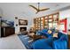 Spacious living room with fireplace, blue sofas, unique shelving, and lots of natural light at 1702 E Staghorn Ln, Carefree, AZ 85377