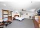Serene main bedroom with a king bed, modern decor, and view to main bathroom at 1702 E Staghorn Ln, Carefree, AZ 85377
