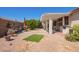Well kept backyard space, highlighting a patio, small seating area, grill, and desert landscaping at 17651 N Coconino Dr, Surprise, AZ 85374
