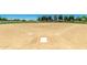 Well-maintained baseball field, complete with neatly marked base paths, backstop, and grassy outfield, ready for a ballgame at 17651 N Coconino Dr, Surprise, AZ 85374