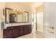 Bathroom with double sink vanity and a glass-enclosed shower at 17651 N Coconino Dr, Surprise, AZ 85374