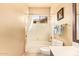 Bright bathroom featuring a shower and tub combo, and a large, white toilet at 17651 N Coconino Dr, Surprise, AZ 85374