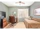Bedroom featuring carpeted floors, soft green walls, a window, and a day bed at 17651 N Coconino Dr, Surprise, AZ 85374