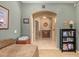Bedroom view with an arched doorway, hallway, and tiled floors leading to another room at 17651 N Coconino Dr, Surprise, AZ 85374
