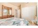 Bright bedroom featuring a dresser with mirror and natural light from a window at 17651 N Coconino Dr, Surprise, AZ 85374