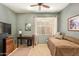 Bedroom featuring carpeted floors, a ceiling fan, a window, and a day bed at 17651 N Coconino Dr, Surprise, AZ 85374