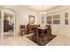 Elegant dining room featuring a chandelier, plantation shutters, and a view into the adjacent rooms at 17651 N Coconino Dr, Surprise, AZ 85374