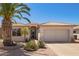 Charming single-story home featuring a well-manicured front yard with desert landscaping and a two-car garage at 17651 N Coconino Dr, Surprise, AZ 85374