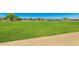 Well-kept green field under a clear blue sky, great for sports, recreation, and community activities at 17651 N Coconino Dr, Surprise, AZ 85374