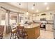 Stylish kitchen with granite countertops, pendant lighting, stainless steel appliances, and a breakfast bar at 17651 N Coconino Dr, Surprise, AZ 85374