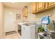 Laundry room with upper cabinets, and a side-by-side washer and dryer at 17651 N Coconino Dr, Surprise, AZ 85374