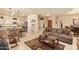 Open-concept living room showcasing tile floors, a comfortable sofa, and seamless flow to the kitchen at 17651 N Coconino Dr, Surprise, AZ 85374