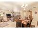 Spacious living and dining area with tile floors, modern lighting, and an open layout at 17651 N Coconino Dr, Surprise, AZ 85374