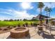 Lush outdoor patio with a fire pit and comfortable seating, perfect for enjoying scenic golf course views at 17651 N Coconino Dr, Surprise, AZ 85374