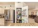 Walk-in pantry with shelving for ample storage, conveniently located near the stainless steel refrigerator at 17651 N Coconino Dr, Surprise, AZ 85374