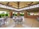 Open-air pavilion featuring tables, chairs, ceiling fans and exposed brick pillars, perfect for outdoor dining and gatherings at 17651 N Coconino Dr, Surprise, AZ 85374