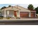 Charming single-story home featuring a tile roof, a two-car garage, and desert landscaping at 17661 W Mariposa Dr, Goodyear, AZ 85395