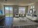 Bright living area with a sliding glass door to the backyard, stylish furniture and contemporary decor at 17961 W Sand Hills Rd, Surprise, AZ 85387