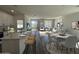 Open-concept living and kitchen area featuring modern countertops, stainless appliances and backyard access at 17961 W Sand Hills Rd, Surprise, AZ 85387