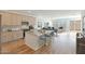 Bright, open-concept kitchen with island seating, modern cabinetry, and stainless steel appliances, flowing into the living area at 17969 W Sand Hills Rd, Surprise, AZ 85387