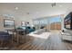 Open living space with large windows, modern furnishings, and a seamless transition to an outdoor patio at 17969 W Sand Hills Rd, Surprise, AZ 85387