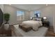 Serene main bedroom with a large window, plush bedding, and neutral decor, creating a relaxing retreat at 17969 W Sand Hills Rd, Surprise, AZ 85387