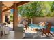 Beautiful backyard pool and patio area with outdoor seating, a rock waterfall, and a built-in BBQ at 1811 S Brentwood Pl, Chandler, AZ 85286