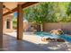 Inviting backyard pool area with a rock waterfall feature, built-in BBQ, and covered patio, perfect for entertaining at 1811 S Brentwood Pl, Chandler, AZ 85286
