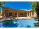 Stunning view of the refreshing backyard pool with rock accents and a spacious covered patio at 1811 S Brentwood Pl, Chandler, AZ 85286