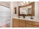 Bathroom boasting double sinks with decorative mirrors, ornate light fixture, and a decorative floral arrangement at 1811 S Brentwood Pl, Chandler, AZ 85286
