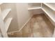 Walk-in closet with adjustable shelving and tile flooring at 1811 S Brentwood Pl, Chandler, AZ 85286