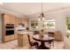 Eat-in kitchen offers a center island, stainless appliances, and pendant lighting at 1811 S Brentwood Pl, Chandler, AZ 85286