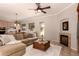 Inviting living room with fireplace, ceiling fan, and views of the backyard at 1811 S Brentwood Pl, Chandler, AZ 85286