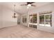 Spacious living room with high ceilings, elegant chandelier, and neutral carpet at 1811 S Brentwood Pl, Chandler, AZ 85286