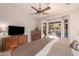 Main bedroom featuring ceiling fan, neutral color walls, and sliding doors accessing the backyard pool at 1811 S Brentwood Pl, Chandler, AZ 85286