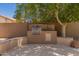 This outdoor grill area features a built-in grill, countertop space, and lush greenery at 1811 S Brentwood Pl, Chandler, AZ 85286