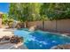 Sparkling pool with a rock waterfall feature surrounded by lush greenery, perfect for relaxation at 1811 S Brentwood Pl, Chandler, AZ 85286