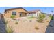 Backyard showcasing desert landscaping with a small green lawn area and rock accents at 18244 W Soft Wind Dr, Surprise, AZ 85387