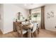 Cozy dining room with wood table, stylish chairs, and a buffet cabinet at 18244 W Soft Wind Dr, Surprise, AZ 85387