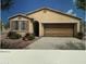 Charming single-story home featuring a two-car garage, arched entryway, and neutral color palette at 18244 W Soft Wind Dr, Surprise, AZ 85387