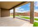 Covered back patio with view of a backyard featuring artificial turf at 18453 W Elwood St, Goodyear, AZ 85338