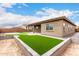 Backyard with a raised garden bed and a covered patio at 18453 W Elwood St, Goodyear, AZ 85338