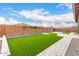 Large backyard with artificial turf and a paved walkway at 18453 W Elwood St, Goodyear, AZ 85338