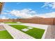 Landscaped backyard with artificial turf and paver walkway at 18453 W Elwood St, Goodyear, AZ 85338