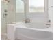 Bright bathroom with white tub and separate glass shower at 18453 W Elwood St, Goodyear, AZ 85338