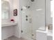 Clean bathroom design featuring glass shower and tub at 18453 W Elwood St, Goodyear, AZ 85338