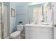 A bright bathroom featuring a vanity, toilet, and glass shower at 18453 W Elwood St, Goodyear, AZ 85338