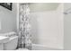 Bathroom with a white shower and a floral-patterned shower curtain at 18453 W Elwood St, Goodyear, AZ 85338